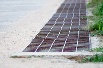 water drain or ditch on the road. Gutters drain grate, drain cover. Road drains