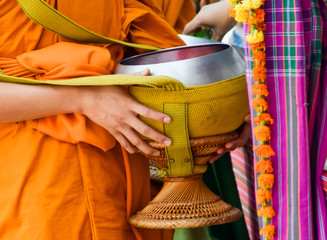 give alms to a Buddhist monk on morning