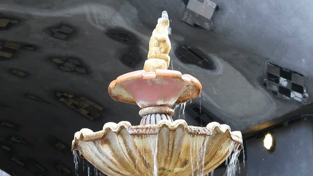 Fresh water fountain running at sunny day near Hundertwasserhaus in Vienna, Austria