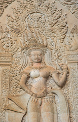 Fototapeta na wymiar The Apsara stone sculpture in the corner of Angkor Wat the world biggest religious place in the world of Siem Reap province, Cambodia.