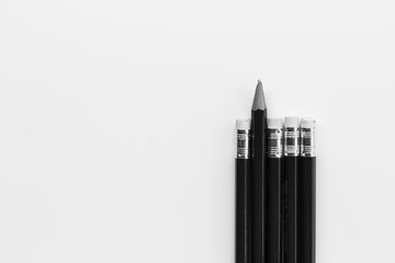pencil standing out from the row of pencils.