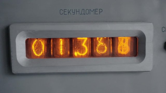 Vintage tube timer counts down the seconds. Three digits after the decimal point. Tube display in the metal frame. Vintage equipment with vacuum tube display. Close up.