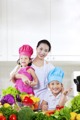 Happy family preparing a salad