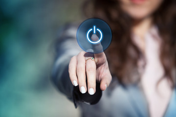 Hand pressing power button on touch screen.