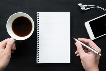 Obraz premium Man is going to write on the notebook. Top view, flat lay.