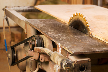 Carpenter tools on wooden table with sawdust. Circular Saw. Carpenter workplace top view