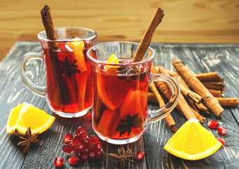Hot mulled wine with apples, pomegranate, orange, anise and cinn