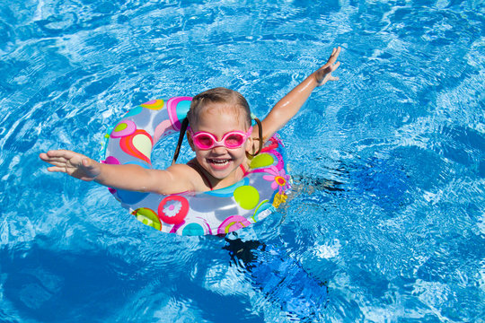 little girl swimming in the pool  in inflatable ring