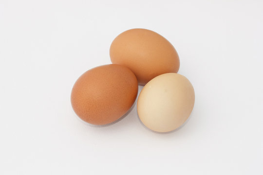 Three hen eggs isolated on white background