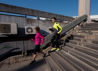 young  couple jogging on steps