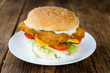 Wooden table with a fresh made Fish Burger