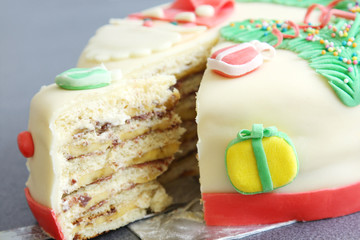 slice, section of decorated with sugar paste christmas cake: cut of banana and chocolate cake