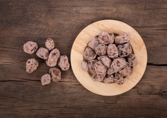 Salted Plum on wooden Background
