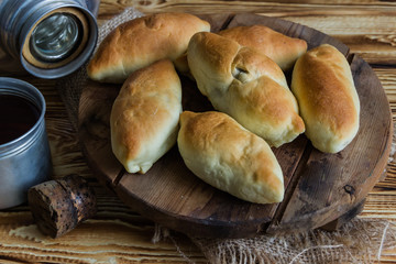 Russian pirozhki ,baked patties, on wooden cutboard