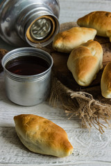 Russian pirozhki ,baked patties, on wooden cutboard