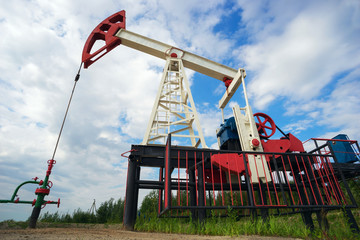 Oil machine-rocking chair in the summer on blue sky background.
