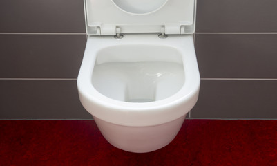 Fototapeta premium closeup of toilet bowl and open lid cover