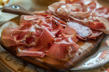 Typical various italian salami, servided on plate at restaurant.