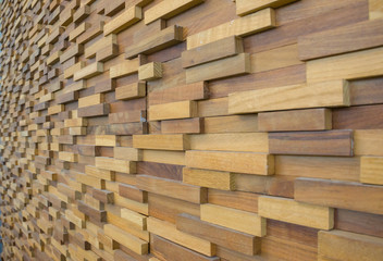 exposed wooden wall exterior, patchwork of raw wood forming a beautiful parquet wood pattern.(selected focus)