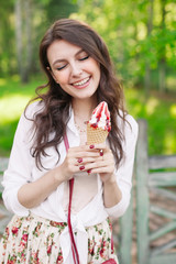 Outdoor closeup portrait of girl eating ice cream in summer