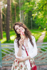 Fototapeta premium Outdoor closeup portrait of girl eating ice cream in summer