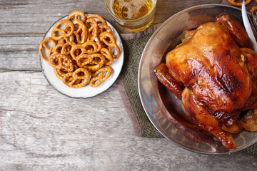 Chicken roasted and pretzels with beer in party