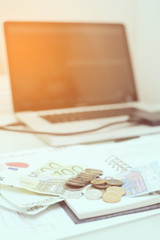 Financial analysis document and part of money and coins stacked