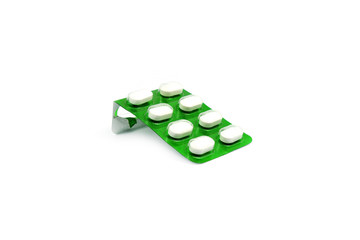 A white medicine in a green tablet on white background