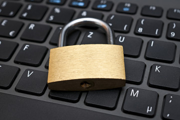 Cyber safety concept - lock on computer keyboard 