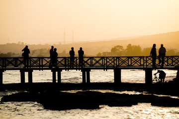 Pier, sunset and silhouettes