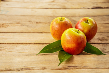 red apple on wood background texture with space for text