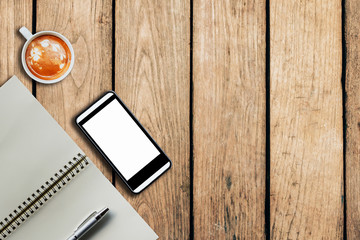 smartphone coffee cup and notebook on wooden background with spa
