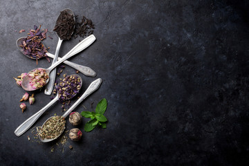 Assortment of dry tea in spoons