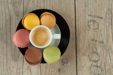 Colorful macaroons over turquoise wood backround