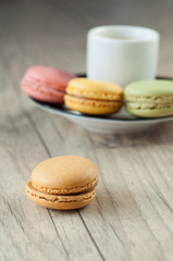 Colorful macaroons over turquoise wood backround