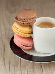 Colorful macaroons over turquoise wood backround