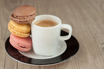 Colorful macaroons over turquoise wood backround
