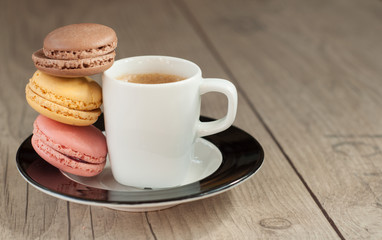 Colorful macaroons over turquoise wood backround
