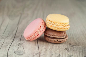 Colorful macaroons over turquoise wood backround