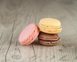 Colorful macaroons over turquoise wood backround