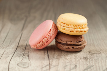 Colorful macaroons over turquoise wood backround