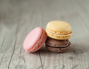 Colorful macaroons over turquoise wood backround