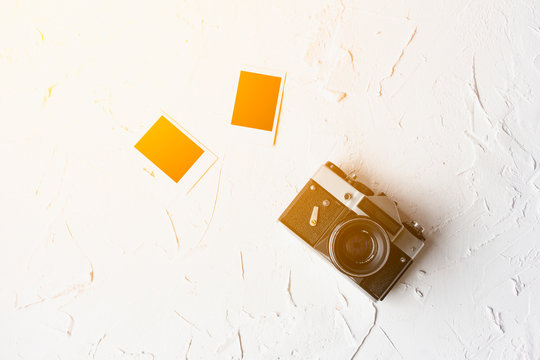 Photo album on white table. instant photo of vintage camera - vintage and retro style, sun