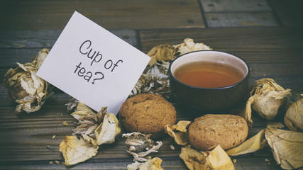 Cup of tea, Oatmeal Cookies and a note on wooden background