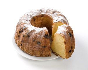 Cake with raisin and sugar on plate on a white background
