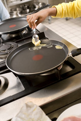 Woman melting the butter in the frying pan