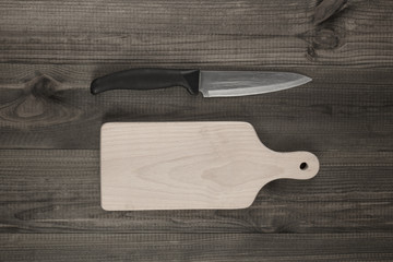 cutting board and knife on wooden table
