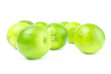 Scattered fresh limes isolated on white