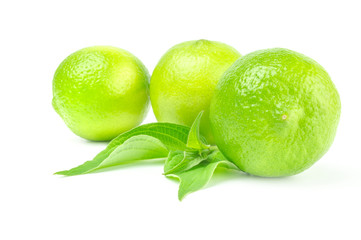 Three fresh limes isolated on white background with leaves