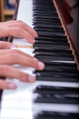 Fototapeta premium Man playing piano with both hands portrait view 3